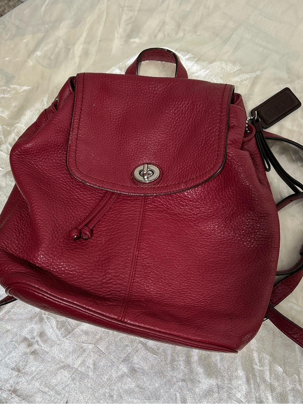 Coach Pebbled Leather Turnlock Drawstring Backpack daypack in Berry Red  F24385